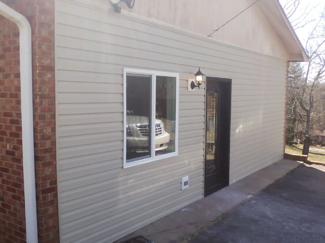 New vinyl siding and entry door on a room addition in Avenue