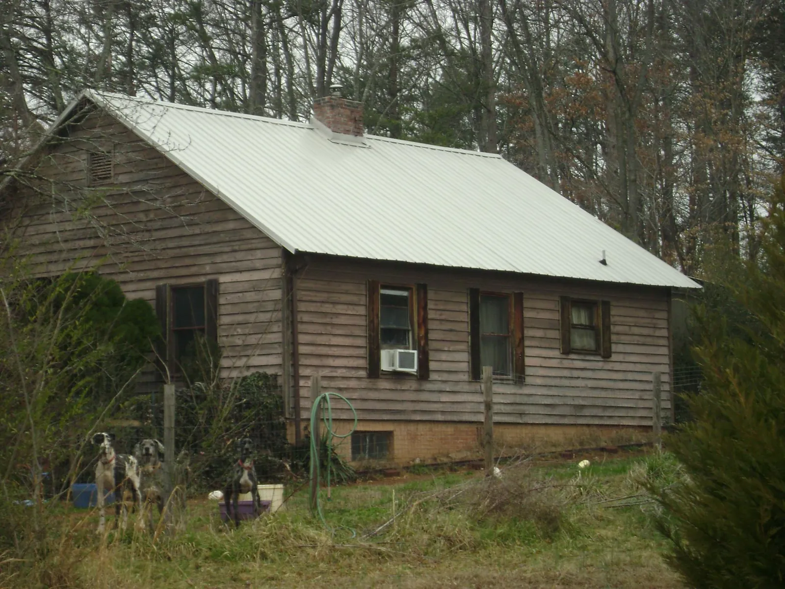 White metal roof on an old wood sided farmhouse, from a Metal Roof Installation job in Avenue